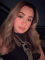 Person with long hair and necklace.