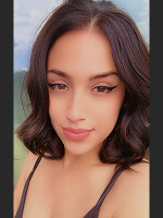 Person with wavy hair outdoors.