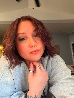 Person with wavy hair indoors.