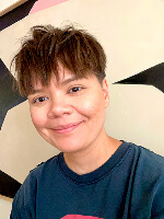 Person with short hair, casual shirt.