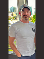 Man in white shirt, city background.