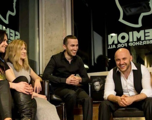 Group of people seated indoors.