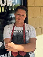 Person wearing an apron, casual shirt.