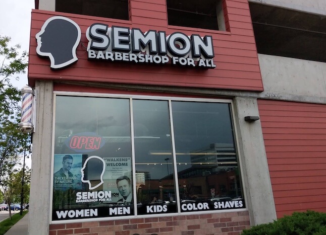 Barbershop sign with services listed.