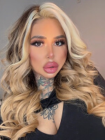 Long wavy hair with blonde highlights.