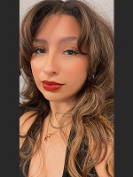 Long wavy hair, stylish outfit.