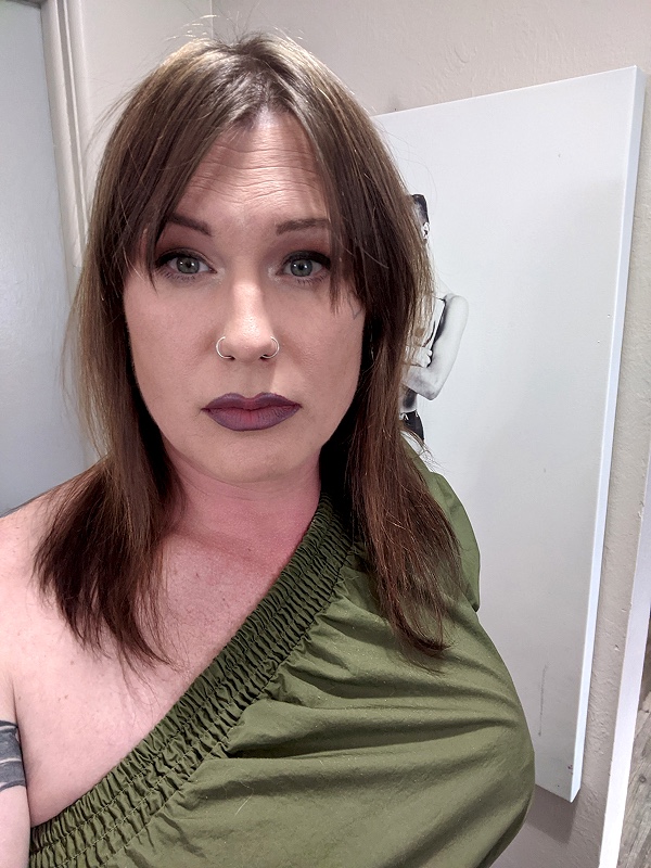 Person in green top, indoor setting.